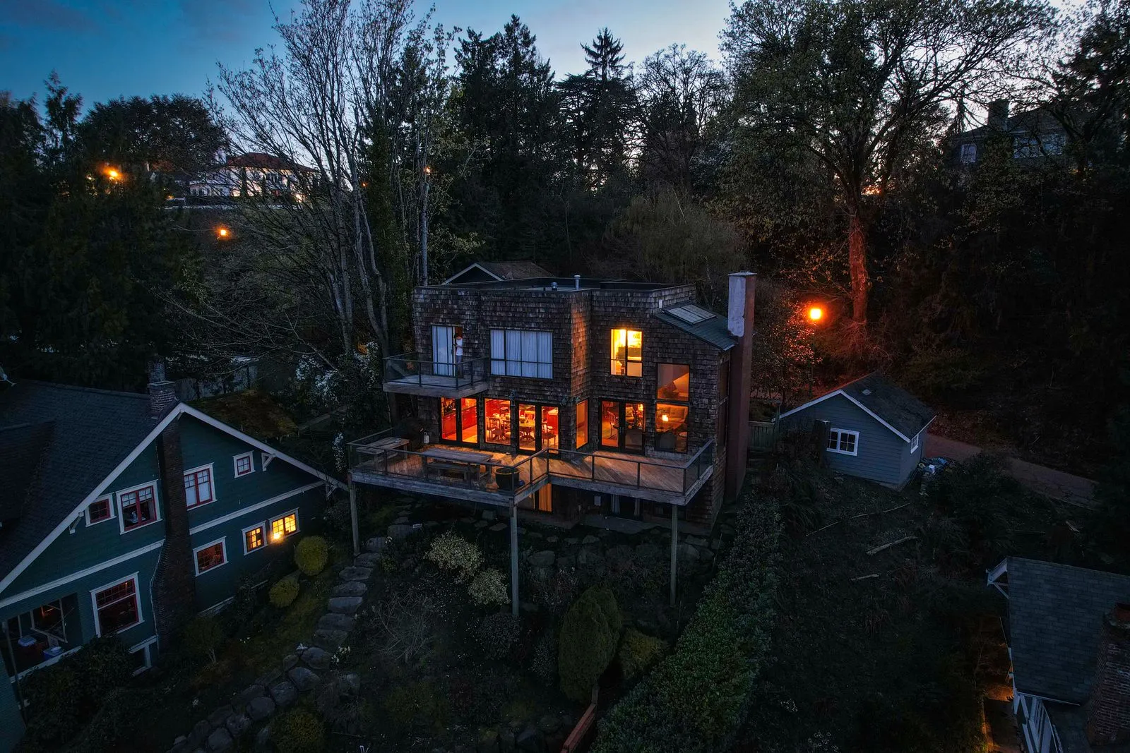 Detached home lit up at dusk, protected by a full security system